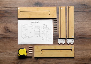 Flat lay composition with furniture parts and tools for self-assembly on wooden background