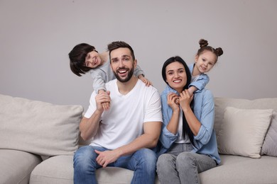 Portrait of happy family on sofa in living room