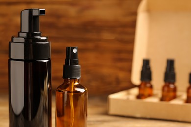 Bottles of oil on wooden table, closeup with space for text. Natural cosmetics