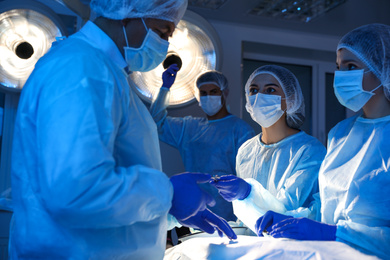 Team of professional surgeons performing operation in clinic