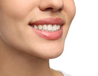 Woman with healthy teeth and beautiful smile on white background, closeup. Cosmetic dentistry