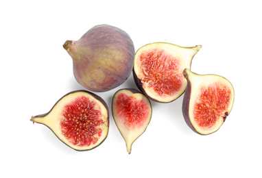 Whole and cut tasty fresh figs on white background, top view