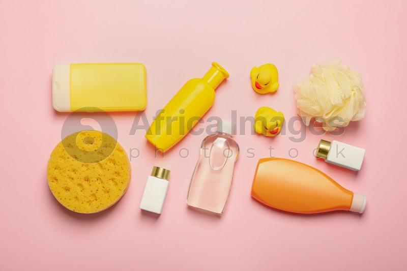 Photo of Flat lay composition with baby cosmetic products on pink background
