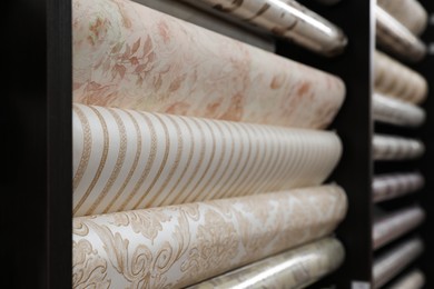Assortment of stylish wall papers on display in shop, closeup