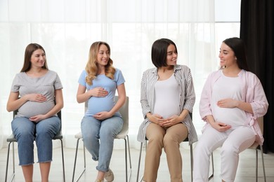 Group of pregnant women at courses for expectant mothers indoors