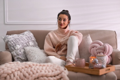 Photo of Beautiful young woman relaxing at home. Cozy atmosphere