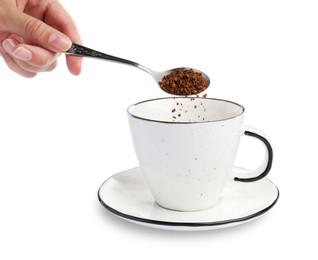 Woman pouring instant coffee into cup on white background, closeup