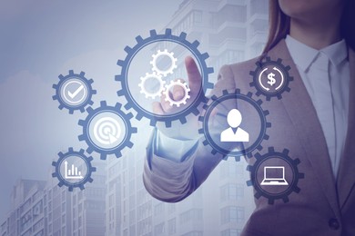 Business process. Woman touching virtual screen with different icons, closeup