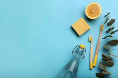 Flat lay composition with eco friendly products on turquoise background, space for text