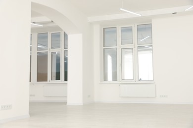 Photo of Modern office room with white walls and windows. Interior design