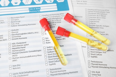 Test tubes with urine samples for analysis on laboratory test form
