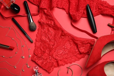 Flat lay composition with sexy lingerie on red background