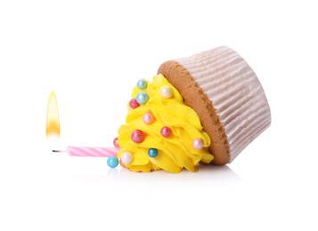 Dropped cupcake with candle on white background. Troubles happen