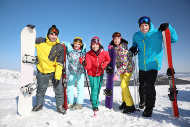 Photo of Group of friends with equipment at ski resort. Winter vacation