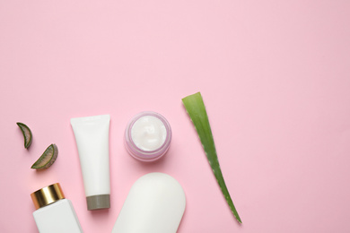 Photo of Flat lay composition with aloe vera and cosmetic products on pink background. Space for text