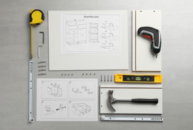 Flat lay composition with furniture parts and tools for self-assembly on light grey background