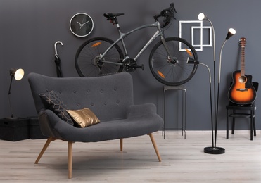 Stylish room interior with bicycle and sofa