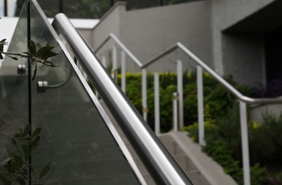 Photo of Outdoor staircase with metal handrails on city street, closeup