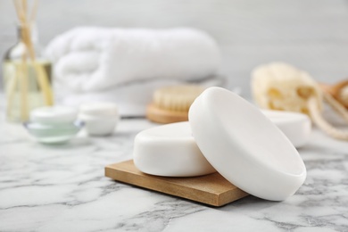 White soap bars on wooden deck in bathroom, closeup