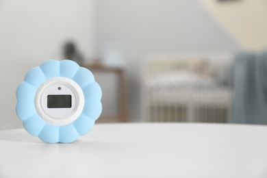 Digital temperature and humidity control in baby room interior. Space for text