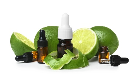Composition with bottles of lime essential oil on white background