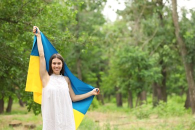 Young woman with flag of Ukraine outdoors