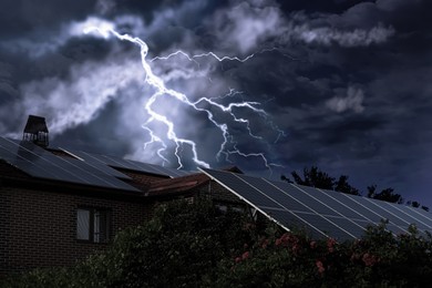 Image of Dark cloudy sky with lightning over house. Stormy weather