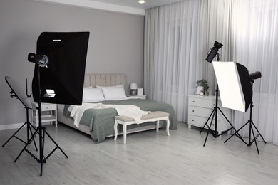 Photo of Professional photo studio equipment prepared for shooting bedroom interior