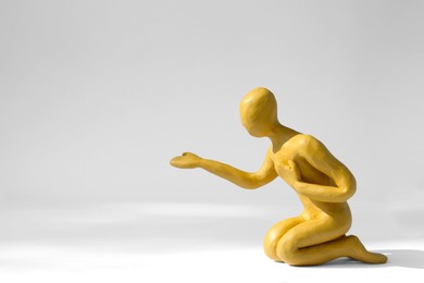 Plasticine figure of human asking help on white background. Space for text