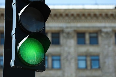 View of traffic light in city on sunny day, closeup. Space for text