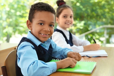 African-American boy wearing new school uniform in classroom