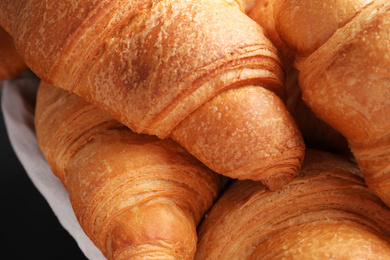 Photo of Closeup view of tasty fresh crispy croissants