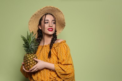 Photo of Young woman with fresh pineapple on olive background, space for text. Exotic fruit