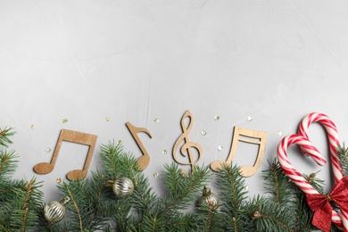 Flat lay composition with music notes on light grey background, space for text. Christmas celebration