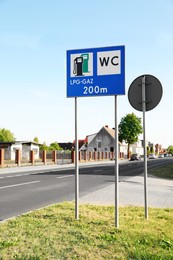 Photo of Traffic signs Petrol Station Equipped Only with Gas for Motor Vehicles and Public Toilet on city street
