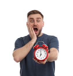 Emotional overslept man with alarm clock on white background. Being late concept