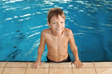 Cute little boy in indoor swimming pool