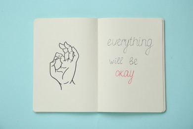 Photo of Notebook with phrase Everything Will Be Okay and drawing of hand showing gesture on light turquoise, top view