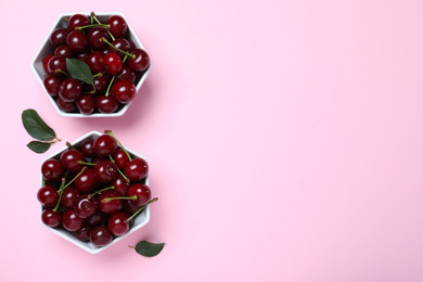 Sweet juicy cherries on pink background, flat lay. Space for text