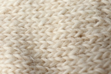 Knitted soft woolen sock as background, closeup