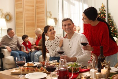 Photo of Happy family enjoying festive dinner at home. Christmas celebration