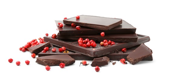 Photo of Red peppercorns and pieces of dark chocolate isolated on white