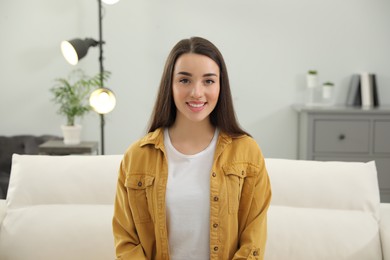 Portrait of happy young woman in room