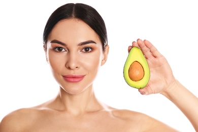 Photo of Young woman with silky skin after face mask holding avocado on white background