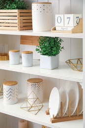 White shelving unit with dishes and different decorative stuff