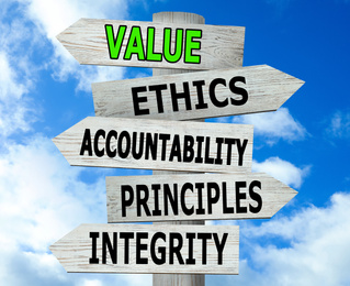 Image of Moral values concept. Wooden signpost with different directions against blue sky