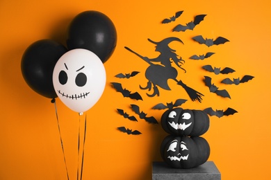 Set of Halloween decorations on color background