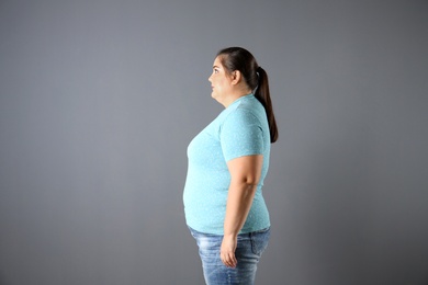 Portrait of overweight woman on gray background