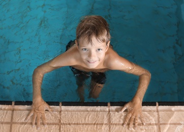 Cute little boy in indoor swimming pool