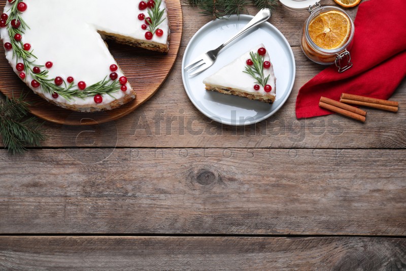 Photo of Flat lay composition with traditional Christmas cake on wooden table. Space for text